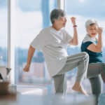 asian chinese senior woman friends enjoying home workout during evening in apartment living room