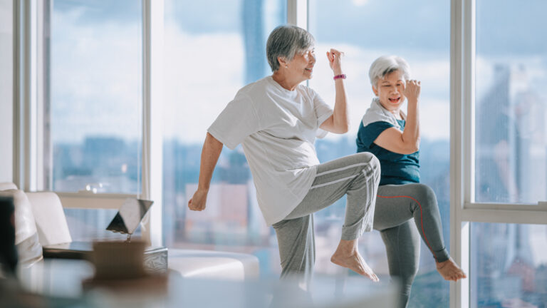 asian chinese senior woman friends enjoying home workout during evening in apartment living room